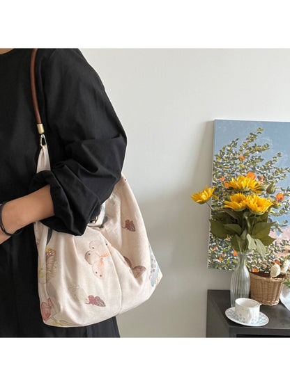 Cosbai tote bag showing soft handles and butterfly design