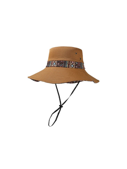 Haila cowboy hat with patterned brim next to rustic decor items