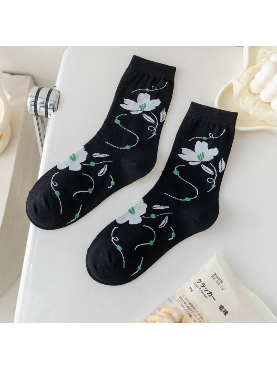 Model wearing Rufia Painterly Flower Mixed Crew Socks with casual shoes and cropped pants