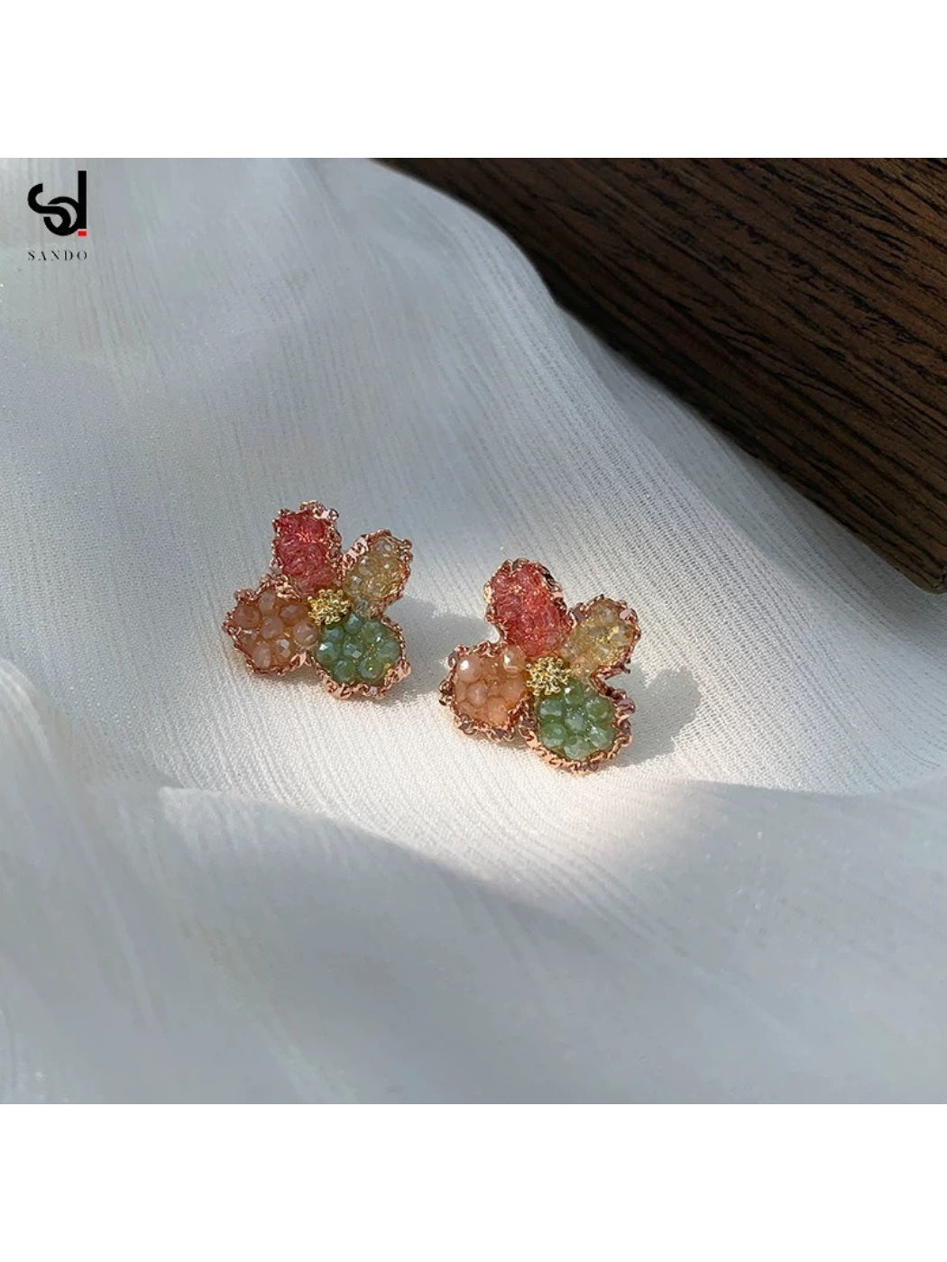 Pair of Earwish Crystal Blossom Cluster stud earrings in a jewelry box with soft lighting