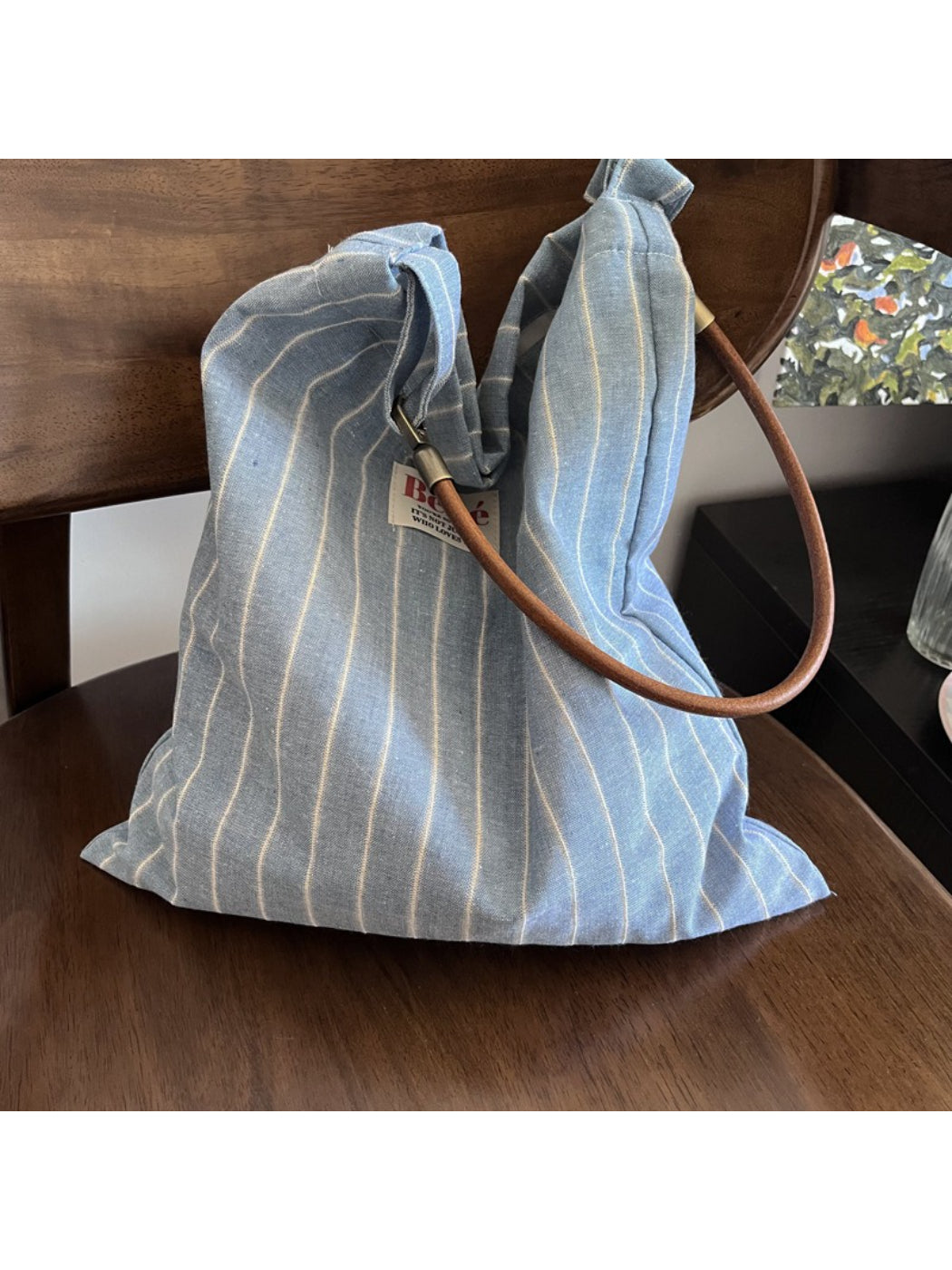 Close-up of Cosbai blue stripe slouch shoulder bag showing fabric texture and strap detail