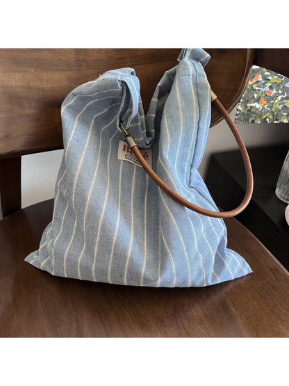 Close-up of Cosbai blue stripe slouch shoulder bag showing fabric texture and strap detail
