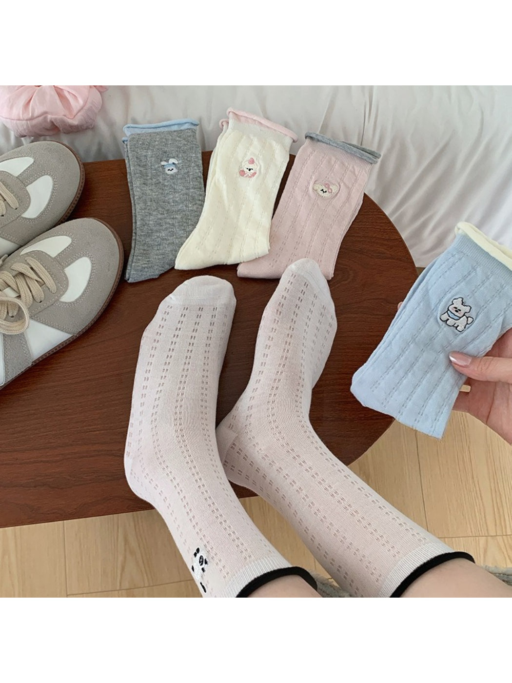 Close-up of Rufia soft roll cuff socks showing detailed character embroidery