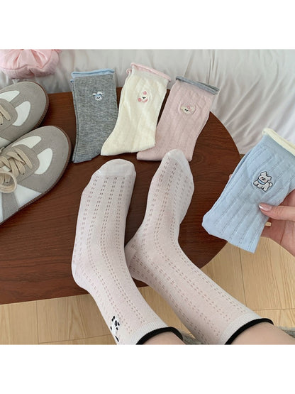 Close-up of Rufia soft roll cuff socks showing detailed character embroidery