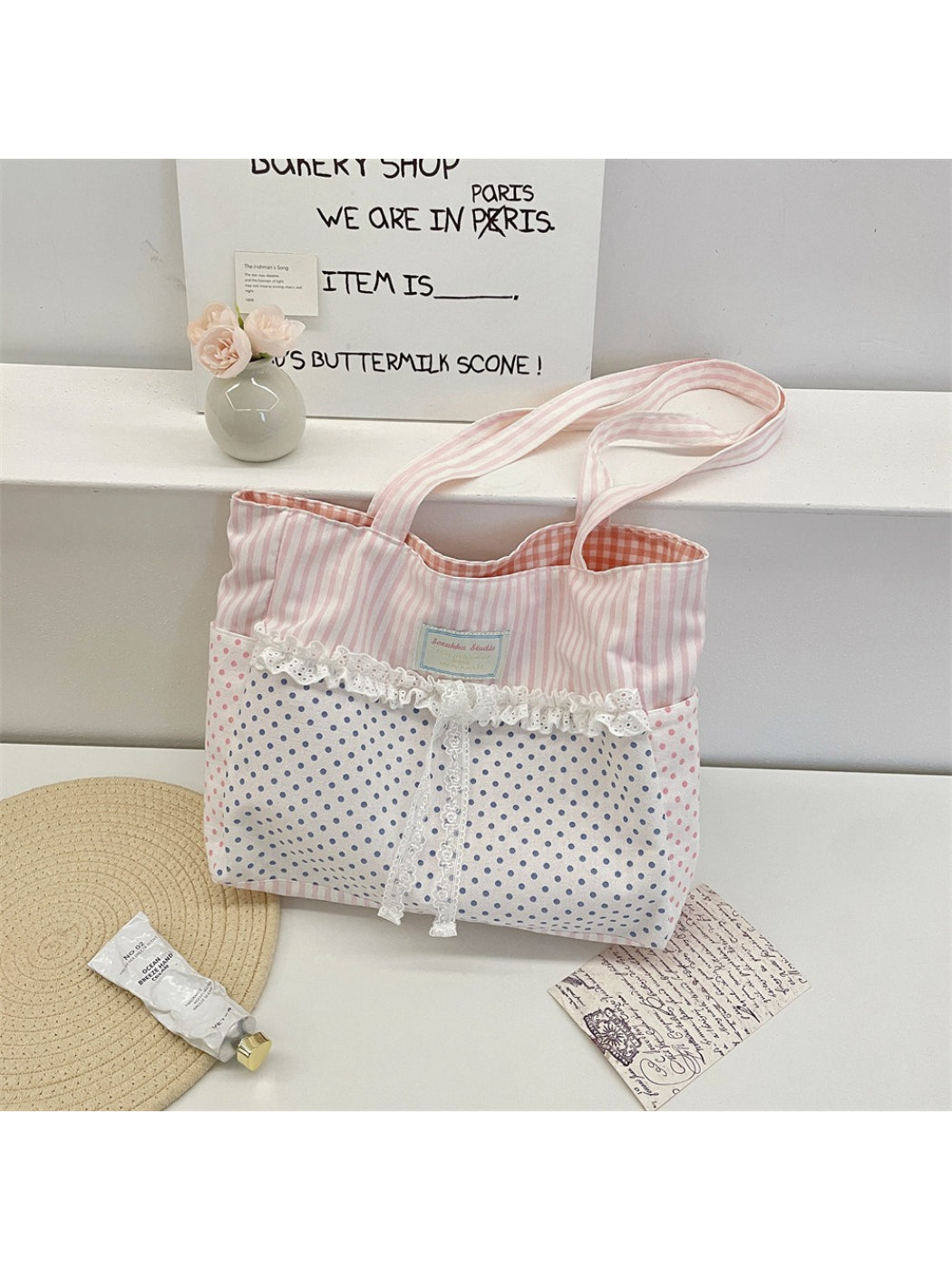 Side view of Cosbai beige shoulder tote bag showing strap and lace design