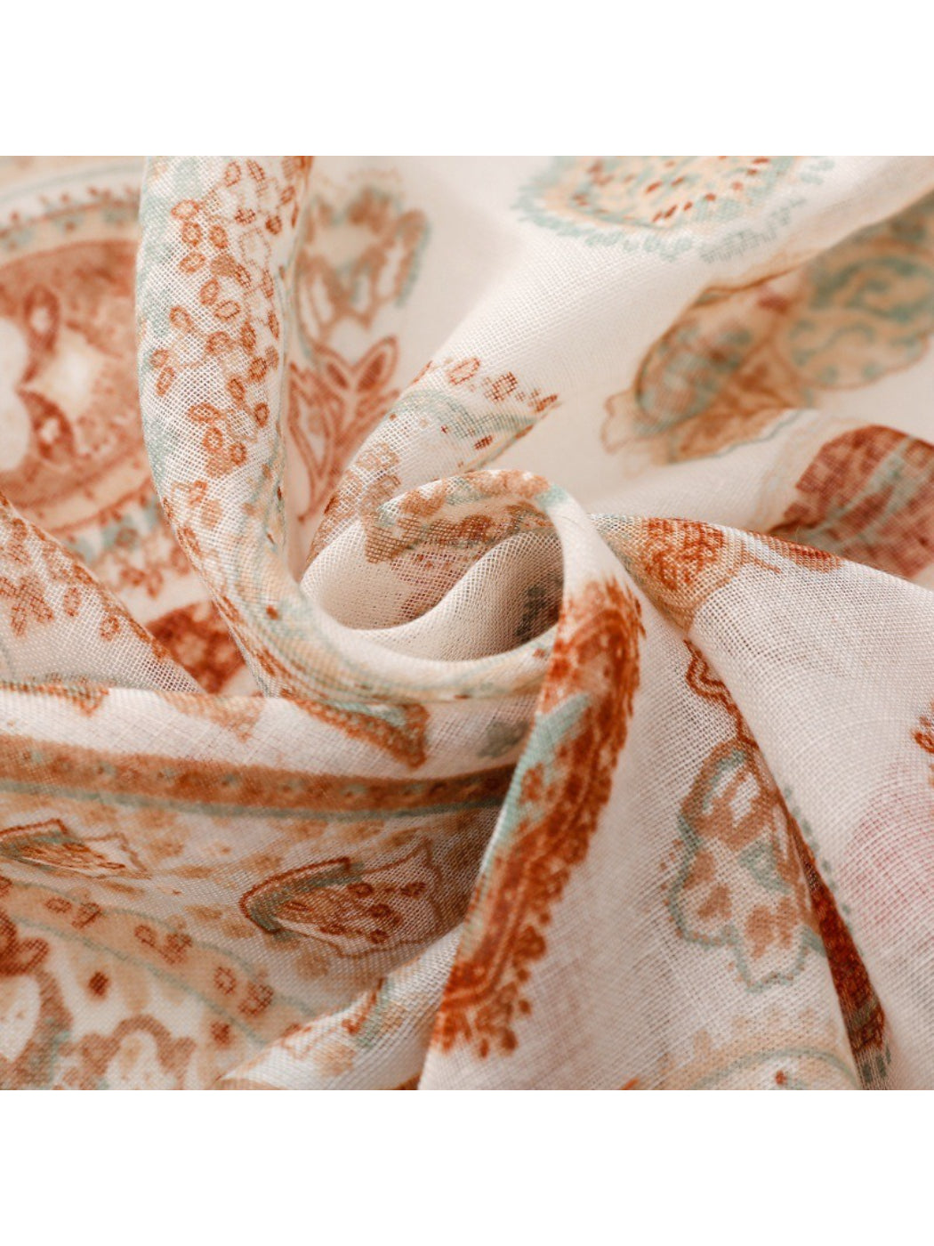 Side view of model showcasing scarf's fringe and paisley design