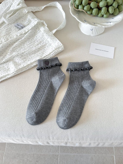 Side view of Rufia Sweet Heart Edge Ribbed Socks highlighting ribbed knit and scalloped cuff