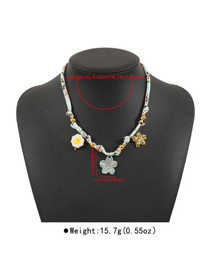 Model wearing Ocean Charm beaded necklace with blue and white beads