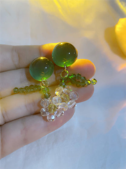 Model wearing Earwish beaded floral dangle earrings with a casual outfit
