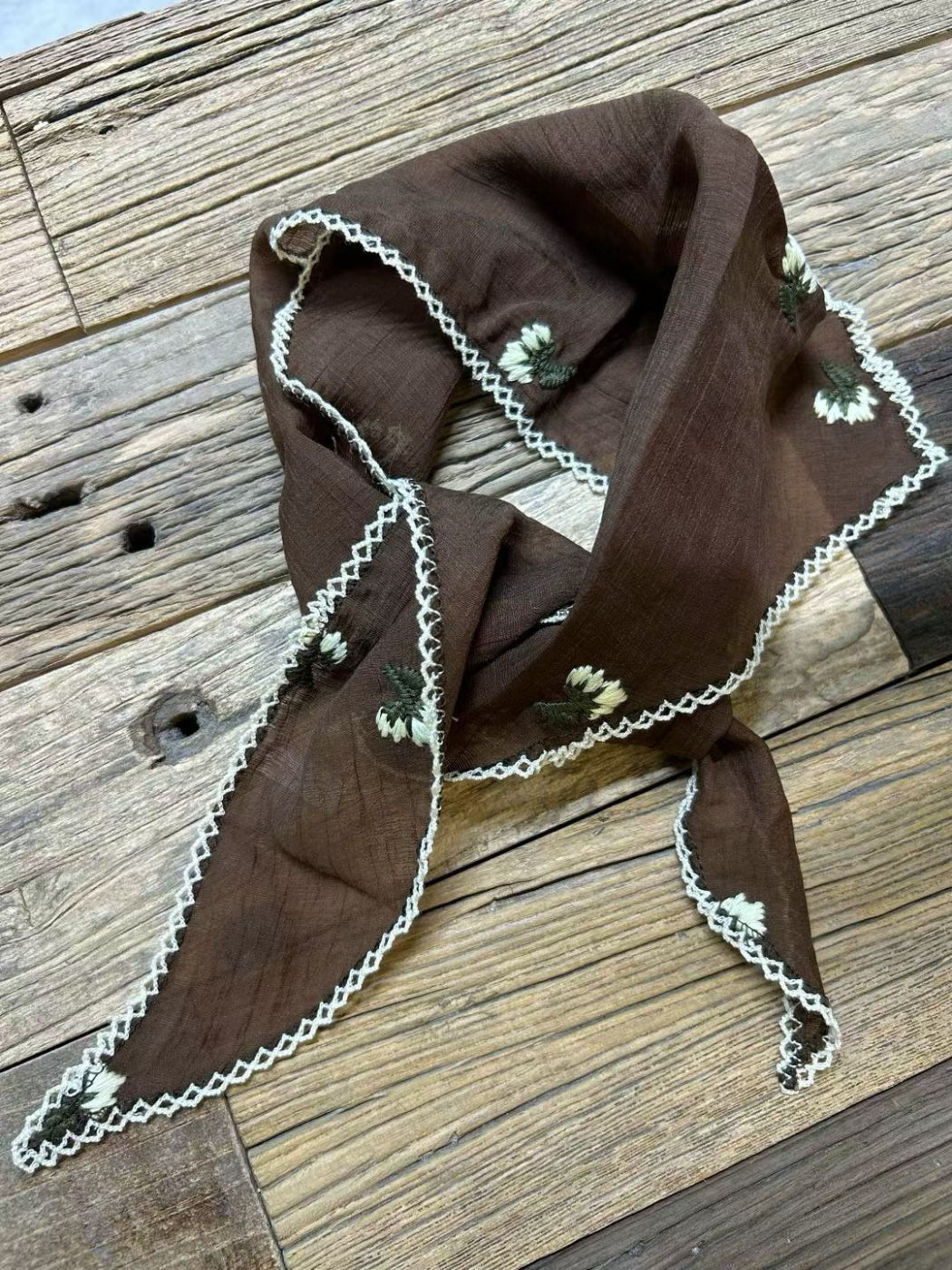 Close-up of vintage floral print on Scarvii triangle bandana scarf with detailed petals and leaves