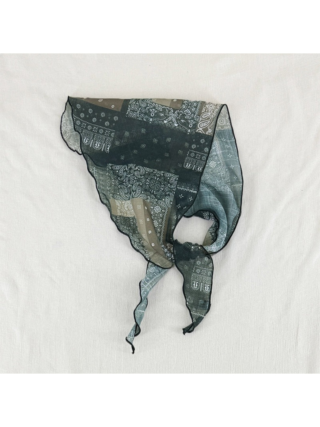 Close-up of Scarvii sheer bandana print scarf showing delicate fabric texture