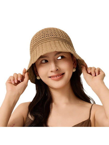 Haila bucket hat folded to show its flexible knit material and lightweight design