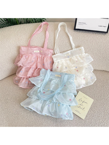 Cosbai pastel mesh tote bag with ruffle detail and beige handles on white background