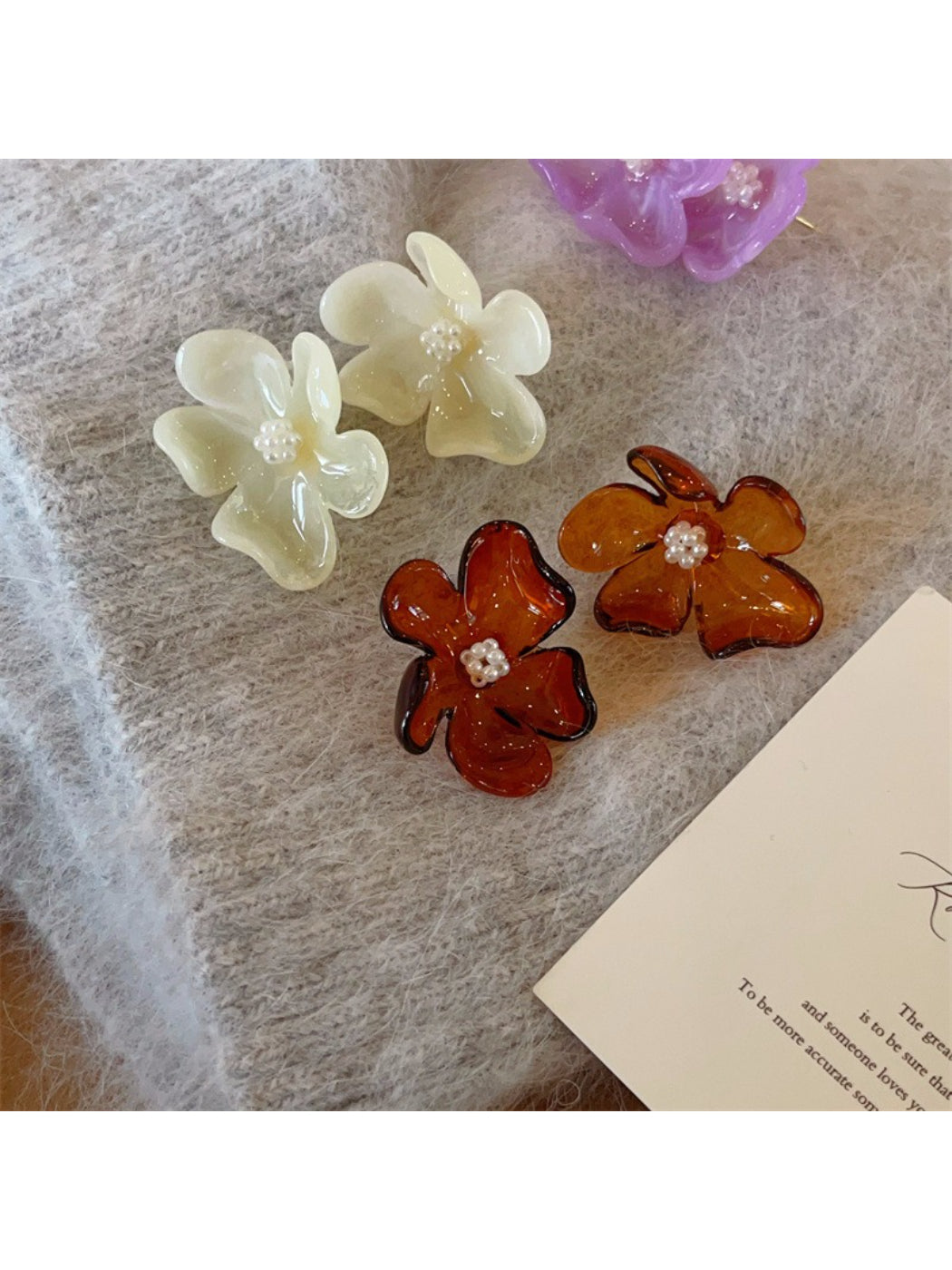 Glossy flower stud earrings with gold-tone metal and detailed petals