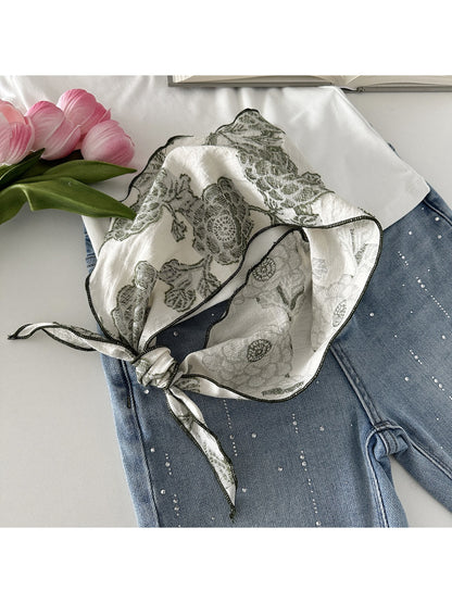 Scarvii scarf laid flat showing full lace print design and soft fabric texture