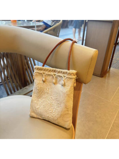 Side view of Cosbai textured floral crossbody bag highlighting slim profile and strap attachment
