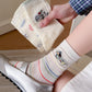 Pair of Rufia Classic Fine Texture Crew Socks in light gray displayed flat