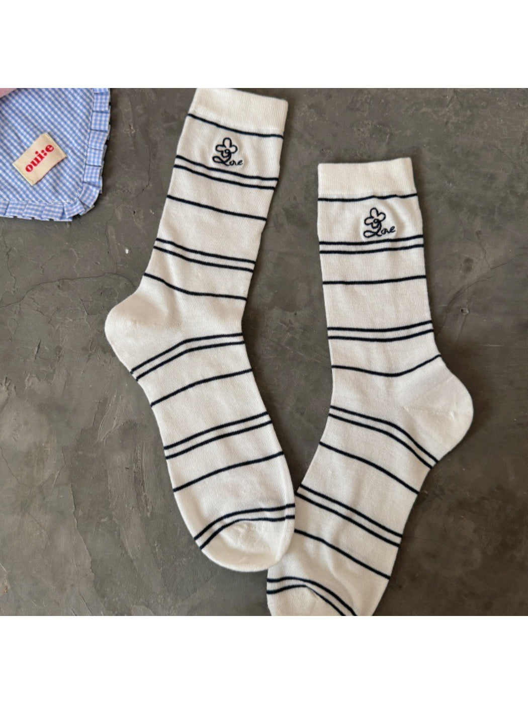 Model wearing Rufia pastel stripe knit socks paired with casual shoes