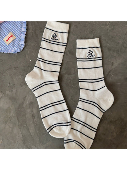 Model wearing Rufia pastel stripe knit socks paired with casual shoes