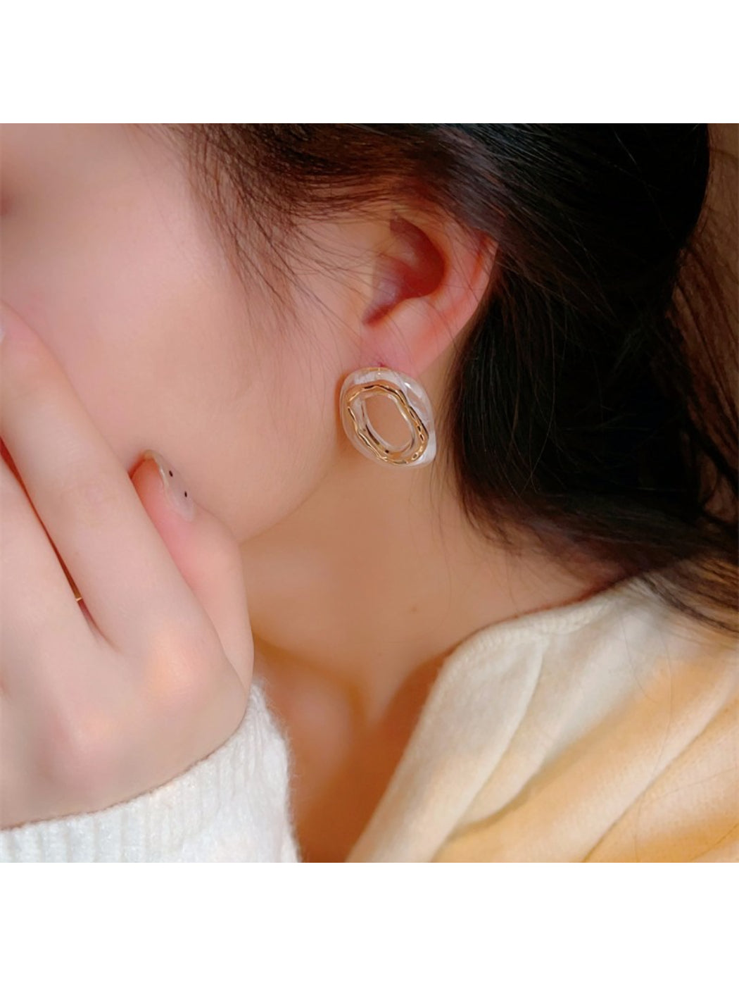 Side view of Earwish modern oval earrings highlighting thickness and shape
