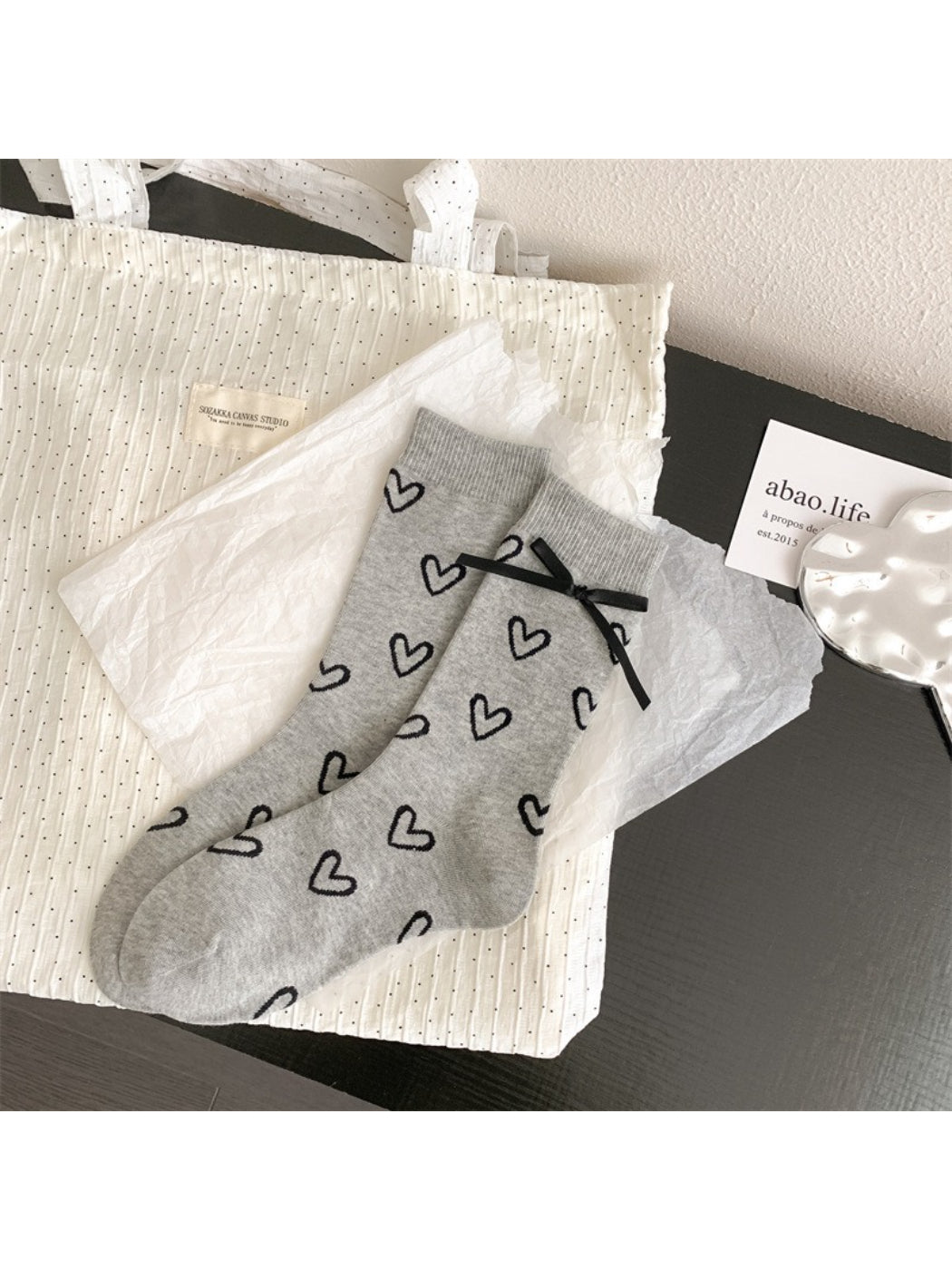 Rufia socks laid flat showing full heart pattern design