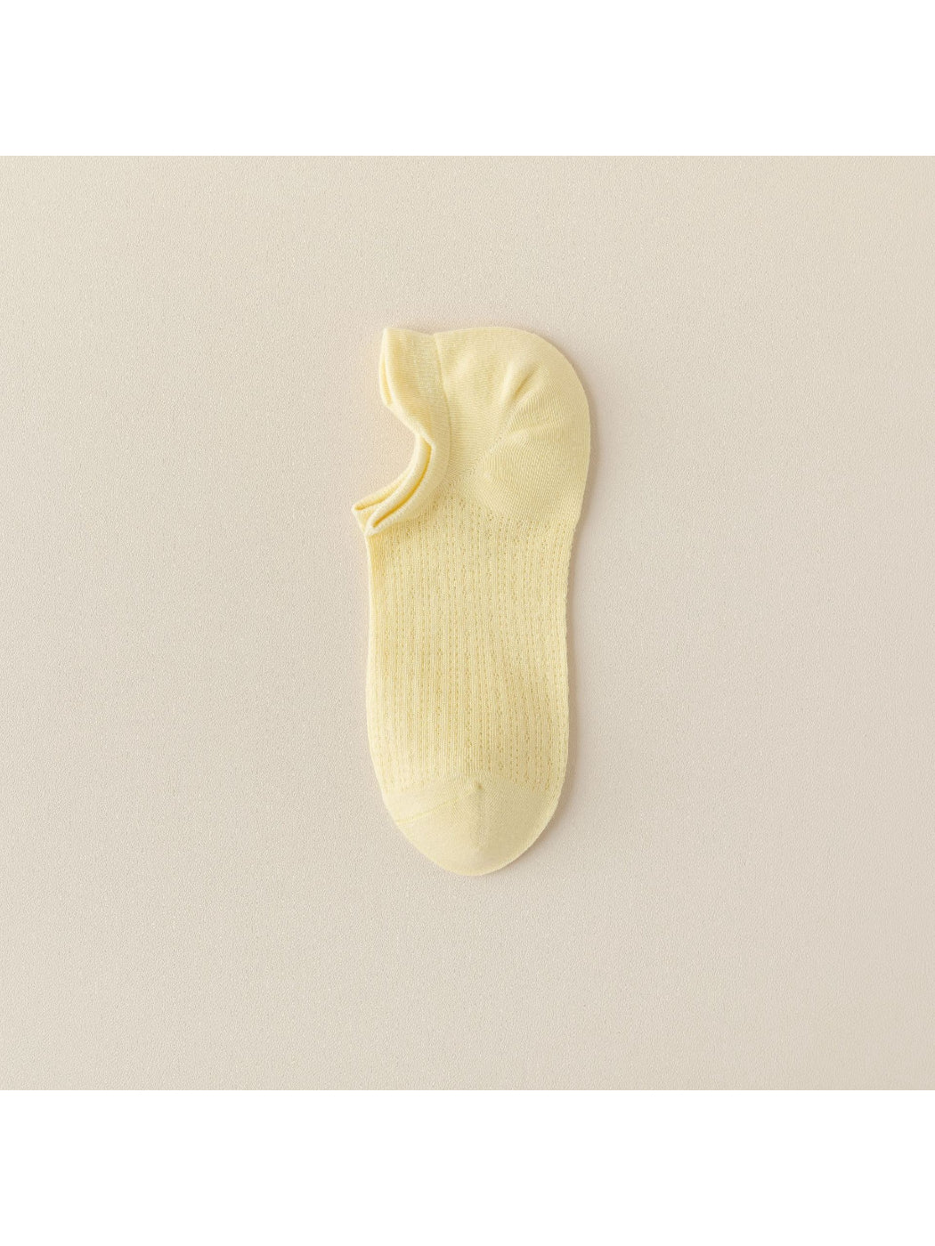 Beige liner sock stretched to show fabric texture and elasticity