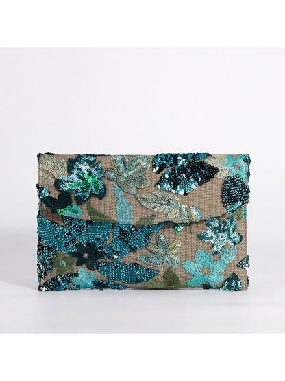 Cosbai clutch bag displayed with accessories on a table