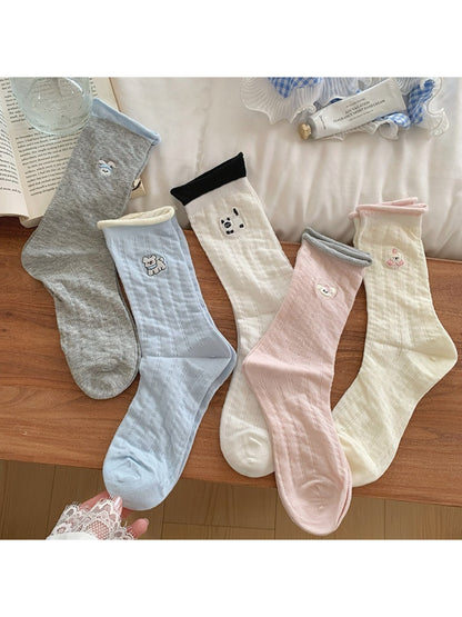 Pair of Rufia soft roll cuff socks with colorful character design on white background