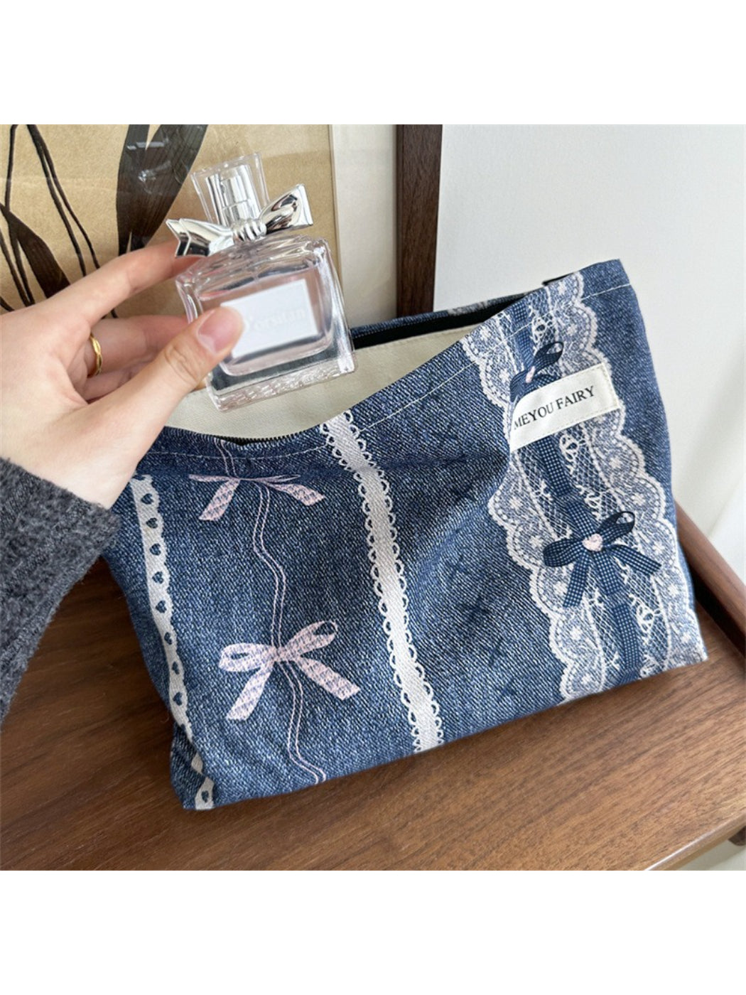 Side view of Cosbai vintage lace cosmetic pouch highlighting its slim profile