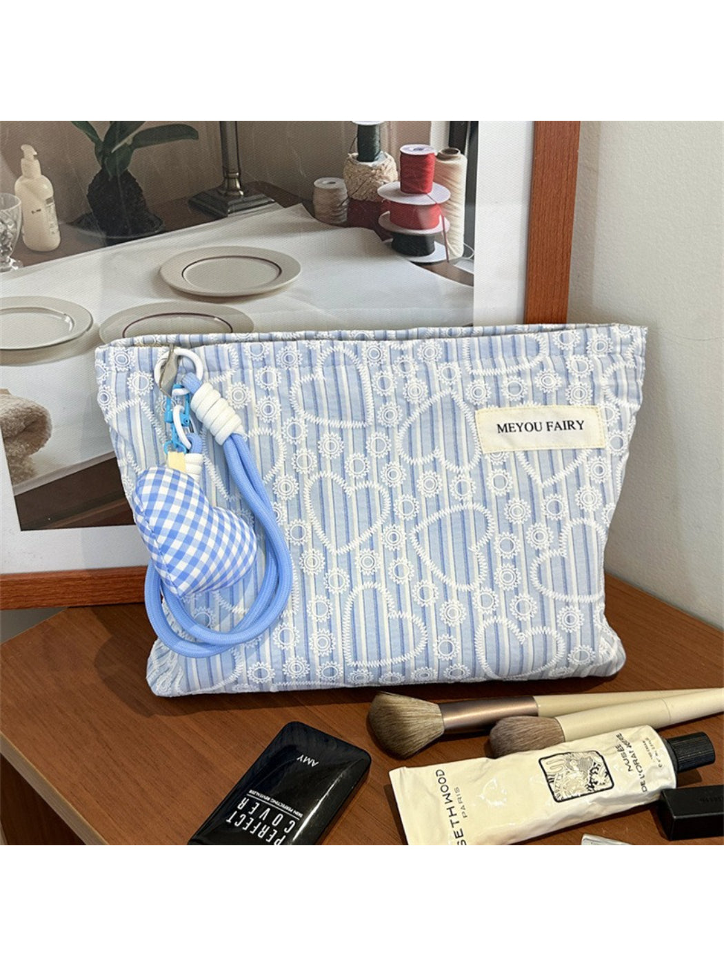 Side view of Cosbai heart print cosmetic pouch highlighting thickness and