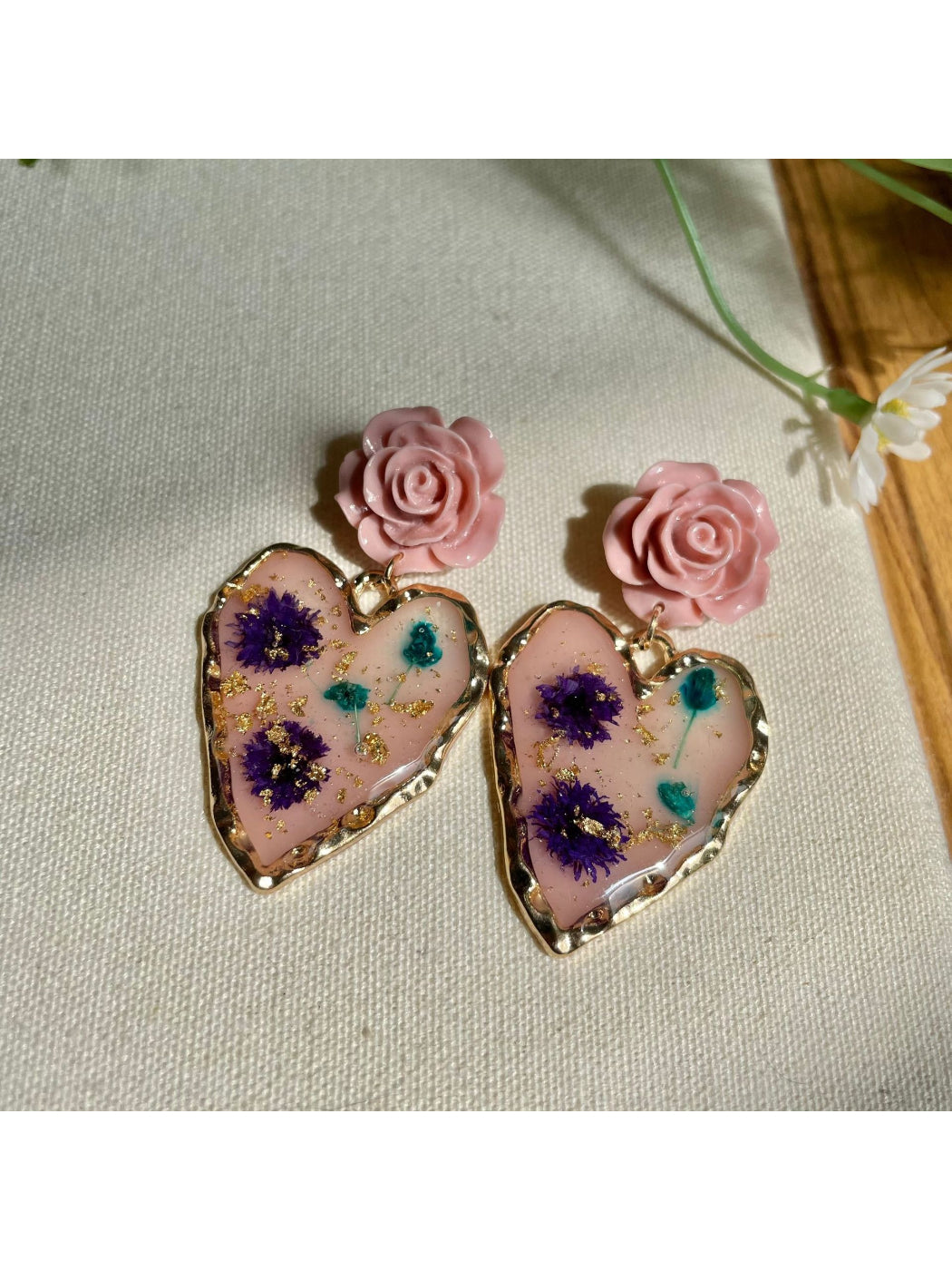 Close-up of Earwish Rose Heart Drop Earrings with pink rose and gold-tone heart charm