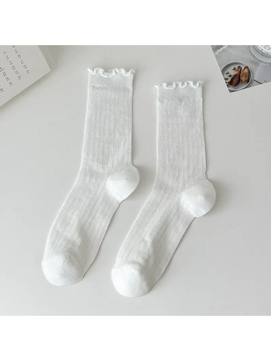 Side view of Rufia soft ribbed crew sock showing ruffle edge