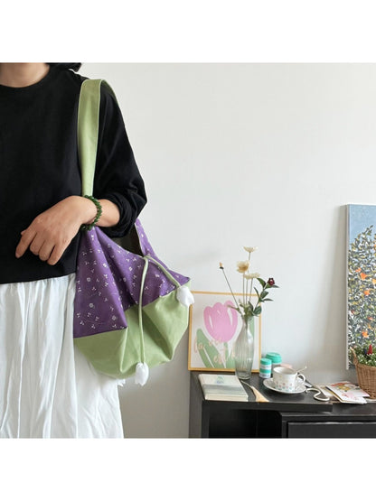 Side view of Cosbai Tulip Charm two-tone slouch bag showing soft leather texture