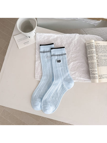 Rufia vintage stripe crew socks paired with rolled-up denim jeans