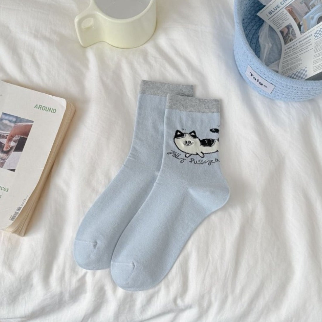 Rufia cat knit crew socks laid flat showing full cat face pattern