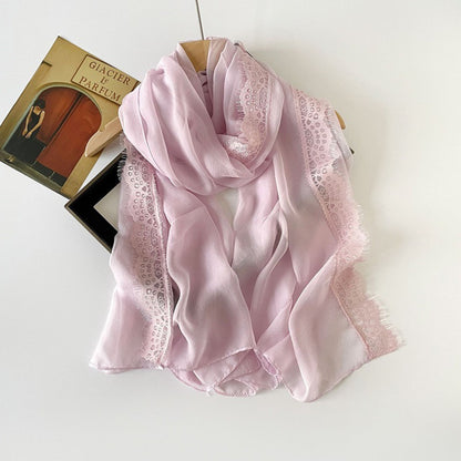 Side view of lightweight scarf with lace border draped over shoulder