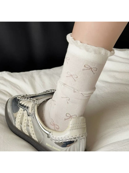 Pair of Rufia Pale Bow Everyday Socks laid flat on a white background