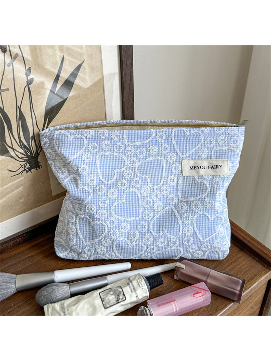 Cosbai makeup bag standing upright on white surface with heart design visible