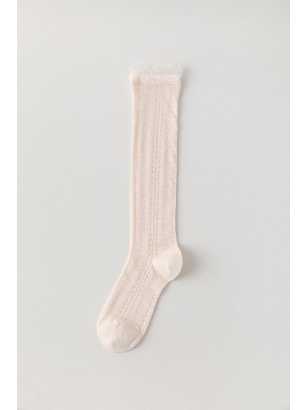 Rufia knee high socks in cream color paired with boots on model