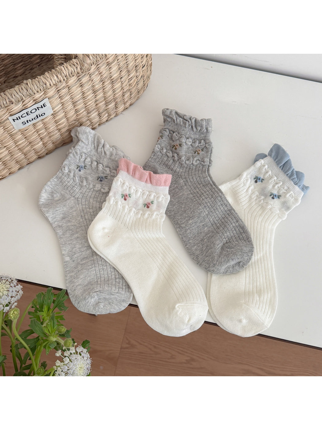 Pair of Rufia soft floral detail ribbed crew socks in light beige color