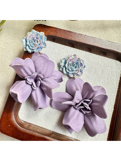 Close-up of Earwish purple floral drop earrings with intricate flower design