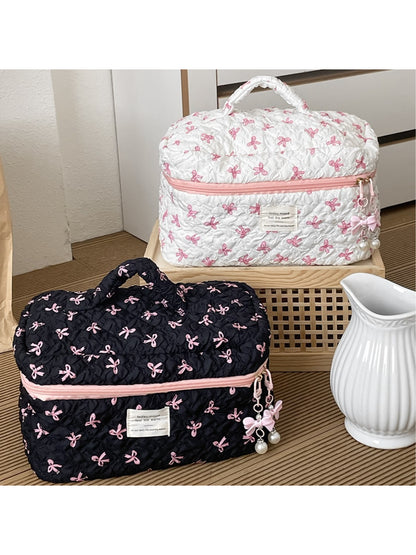 Close-up of Cosbai travel makeup bag showing pink bow pattern and fabric texture