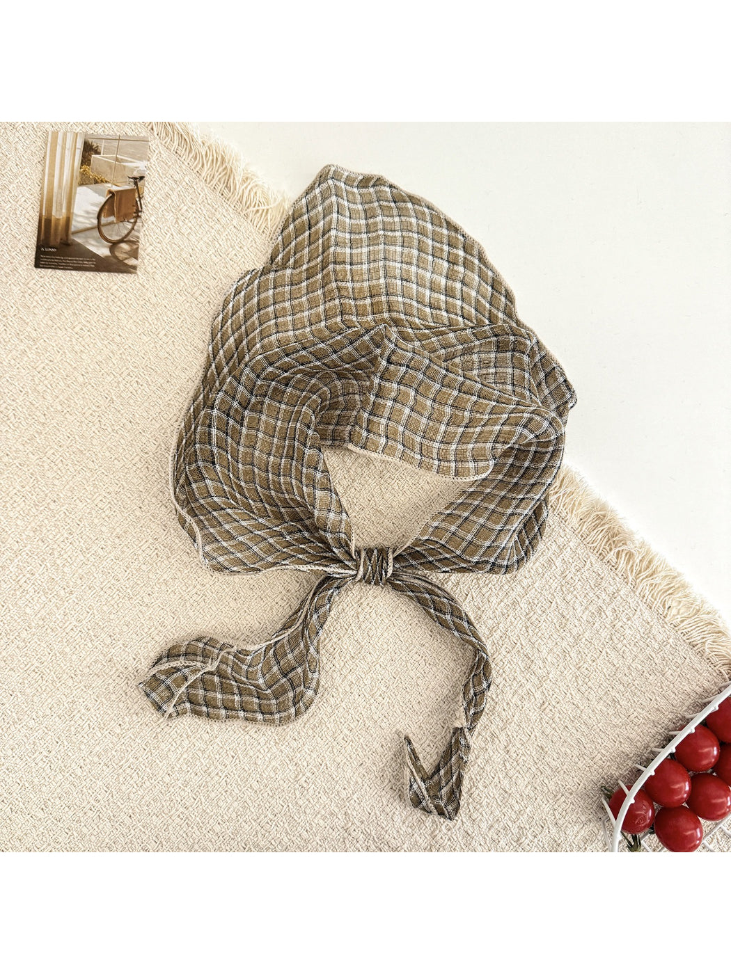 Scarvii triangle scarf folded in a triangle shape with visible plaid stripe pattern