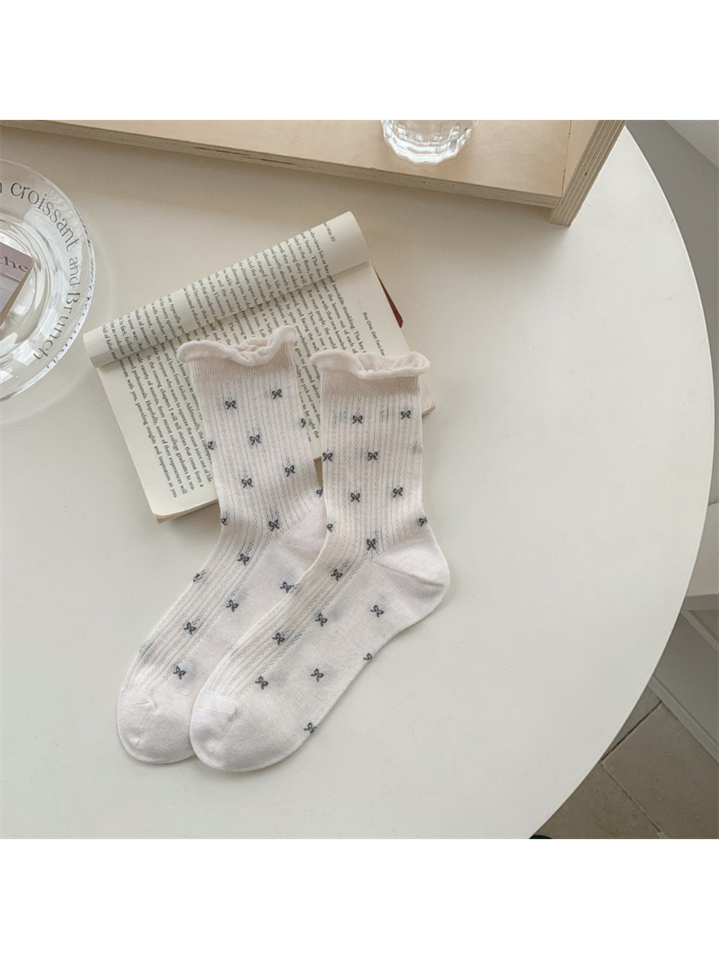 Side view of Rufia crew sock highlighting flower motif and heel design