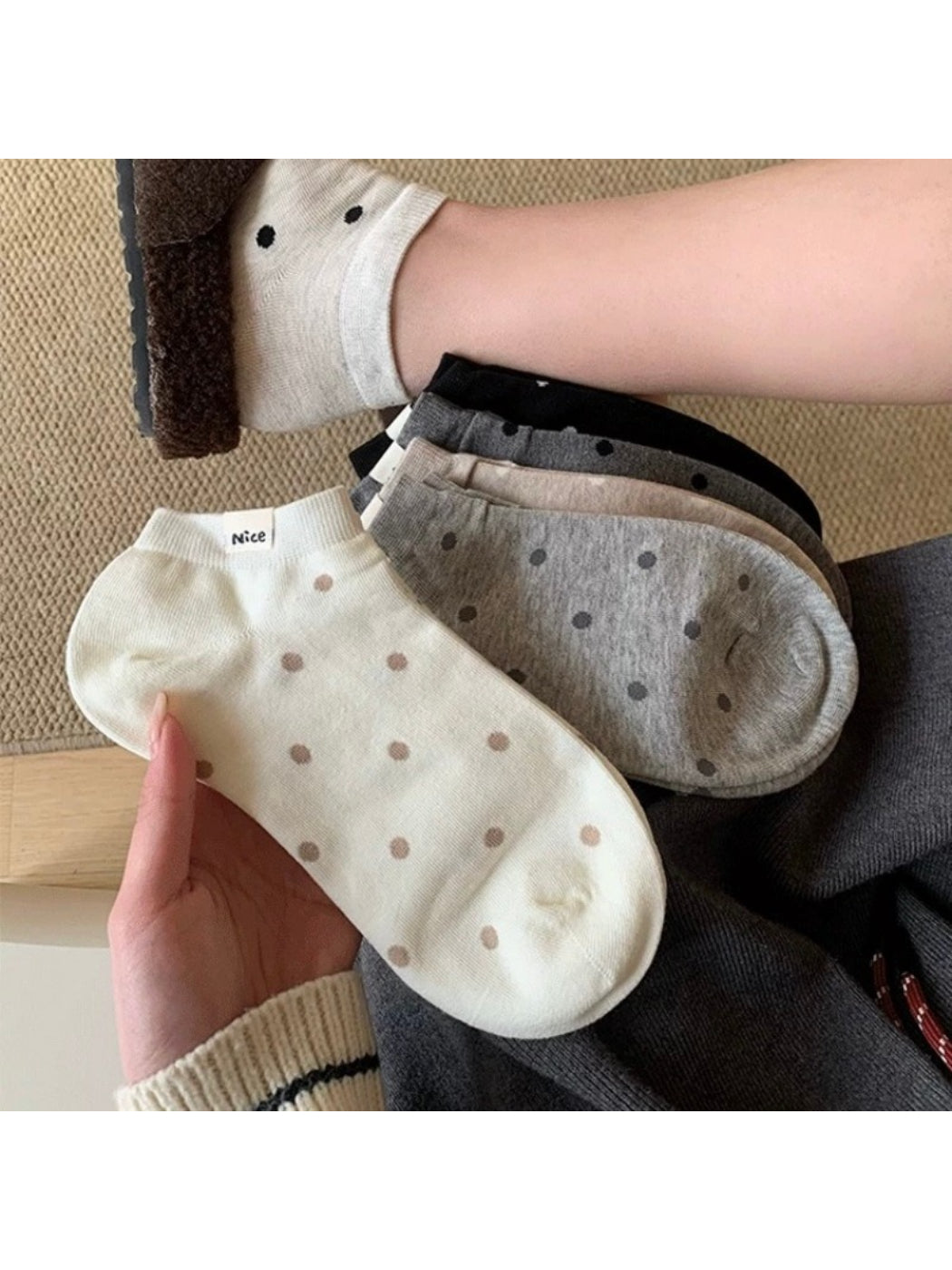 Pair of Rufia Everyday Polka Dot Socks in white with black dots displayed flat