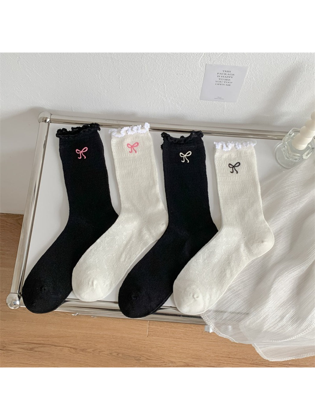 Model wearing Rufia bow detail crew socks with lettuce edge, styled with casual shoes