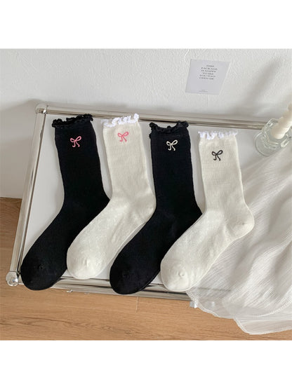 Model wearing Rufia bow detail crew socks with lettuce edge, styled with casual shoes