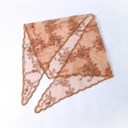 Haila floral lace veil head scarf laid over a wooden surface with soft lighting