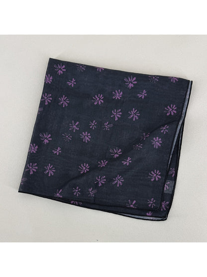 Flat lay of Scarvii square scarf fully spread showing all-over daisy floral design