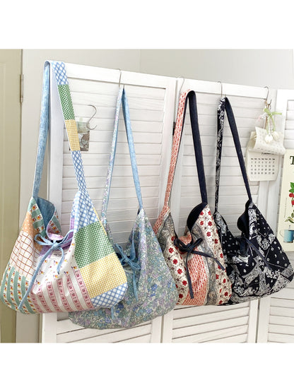 Cosbai reversible patchwork slouchy shoulder bag in neutral tones on white background